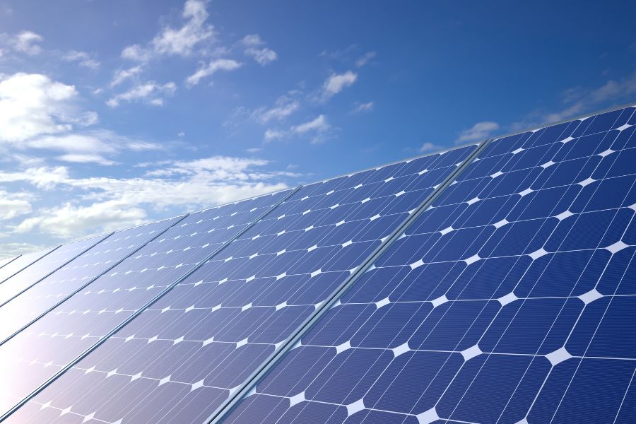 Row of solar panels under blue sky