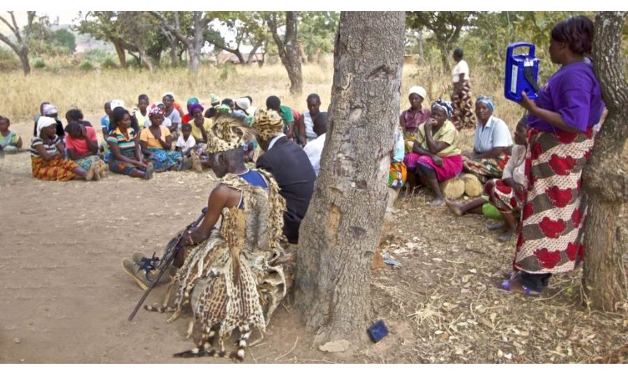 A group of villagers listening to radio