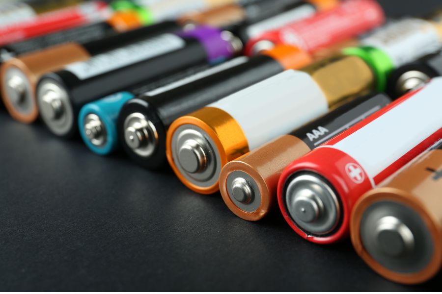 Many different batteries on black surface