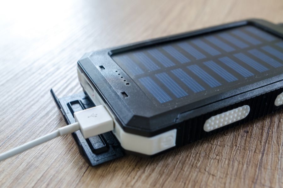 Solar power bank on table with plugged cable